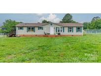 Charming single-story home featuring a well-maintained lawn, complemented by green shutters and a welcoming front porch at 110 Crescent Heights Dr, Salisbury, NC 28146