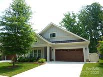 Charming one-story home featuring a two-car garage and beautifully landscaped front yard at 1311 Stonecroft Nw Ln, Concord, NC 28027