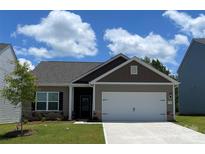 Charming single-story home features a two-car garage, stone accents, and a well-manicured lawn at 1518 Doran Ter, Richburg, SC 29729