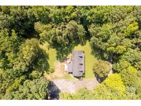 Stunning aerial view of home surrounded by lush green trees and a well-maintained yard at 1738 Charlotte Hwy, Lancaster, SC 29720