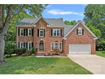 Beautiful brick home with a well-manicured lawn and a two-car garage at 19746 Valiant Way, Cornelius, NC 28031