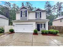 Charming two-story home features a two-car garage, manicured bushes, and black shutters at 2618 Mt Holly Huntersville Rd, Charlotte, NC 28214