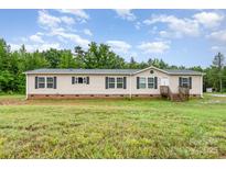Charming single-story home featuring a well-maintained lawn and traditional architecture with black shutters at 4518 Logging Rd, Lancaster, SC 29720