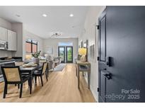 Open-concept living space with modern decor, hardwood floors, and plenty of natural light at 482 New Bern Station Ct, Charlotte, NC 28209