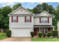 Charming two-story home with red shutters, stone accents and a two car garage in a well-maintained yard at 4837 Autumn Oak Dr, Charlotte, NC 28269