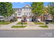 Charming townhomes feature manicured lawns, individual driveways, and inviting entrances with brick and siding facades at 9800 Walkers Glen Nw Dr, Concord, NC 28027