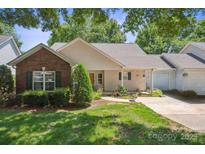 Charming single story home featuring manicured lawn and tidy landscaping in a well-maintained community at 119 Ashwood Ln, Mooresville, NC 28117