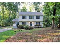 Charming two-story home with a manicured lawn and lush landscaping, perfect for suburban living at 14027 Hackamore Dr, Matthews, NC 28105