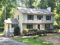 Charming two-story home featuring a landscaped yard and classic architectural details at 14027 Hackamore Dr, Matthews, NC 28105