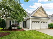 Charming home featuring a two-car garage and a well-manicured lawn with beautiful landscaping at 147 Wren Hill Dr, Mooresville, NC 28115