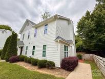 Charming two-story home features a well-manicured lawn, lush landscaping, and a welcoming pathway at 1519 Briar Creek Rd # B, Charlotte, NC 28205