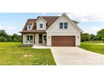 Charming two-story home with a brown garage, inviting front porch, and well-manicured lawn at 181 Lone Pine Rd, Statesville, NC 28625