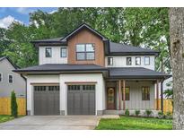 Beautiful two-story home featuring a two-car garage and a charming covered front porch at 1834 Arnold Dr, Charlotte, NC 28205