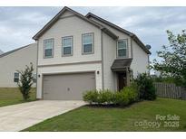 Charming two-story home with a well-maintained lawn and attached two-car garage at 211 Hidden Lakes Rd, Statesville, NC 28677