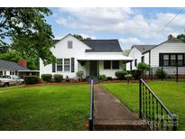 Charming white home with a well-manicured lawn, walkway, and inviting front porch at 441 Jackson St, Rock Hill, SC 29730