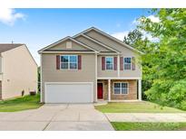 Charming two-story home with a well-maintained lawn, two car garage and classic curb appeal at 5311 Oakdale Ridge Rd, Charlotte, NC 28216