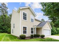 Charming two-story home featuring a well-maintained lawn and a two-car garage at 6229 Sid Crane Dr, Charlotte, NC 28216