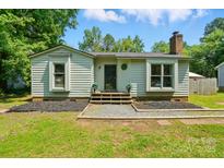 Charming single story home with a chimney, green yard and landscaped front at 6718 Pueblo Ln, Charlotte, NC 28227