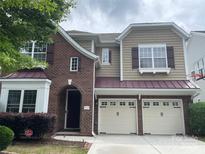 Charming two-story brick and siding home with a two-car garage and manicured landscaping at 9429 Ridgeforest Dr, Charlotte, NC 28277