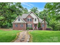 Charming brick home with a manicured lawn and stone pathway leading to a welcoming red door at 2030 Fasana Rd, York, SC 29745