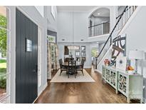 Elegant dining area with a chandelier, hardwood floors, and seamless access to the adjacent living area at 224 Wendover Heights Cir, Charlotte, NC 28211