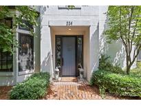 Elegant front door framed by lush greenery and lantern-style lighting creating a welcoming entrance at 224 Wendover Heights Cir, Charlotte, NC 28211