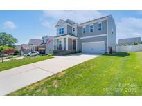 Traditional two-story home featuring gray siding, a red front door, and a well-manicured lawn at 4117 Sunset Ridge Dr, Rock Hill, SC 29732
