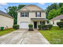 Charming two-story home featuring a garage, manicured landscaping, and a welcoming front entrance at 4916 Oak Pasture Ln, Charlotte, NC 28269