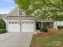 Charming home featuring a two-car garage, complemented by well-maintained landscaping and a cozy, inviting entrance at 5306 Prosperity View Dr, Charlotte, NC 28269