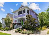 Eye-catching two-story home with a spacious porch, green door, manicured landscaping and vibrant purple facade at 536 Spring Landing Dr, Rock Hill, SC 29730