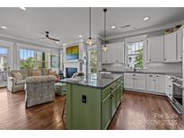 Open concept living room features a fireplace, comfortable seating, and flows into a modern kitchen with an island at 536 Spring Landing Dr, Rock Hill, SC 29730