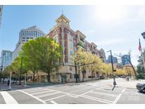 Stunning condo building with brick facade, lush trees, and inviting architecture, located in a vibrant city setting at 580 N Church St, Charlotte, NC 28202