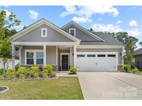 Charming single-story home featuring a well-manicured lawn, a two-car garage, and a welcoming front porch at 9009 Myrna Dr, Gastonia, NC 28056