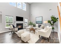 Bright living room features high ceilings, fireplace, and comfortable seating at 10198 Tintinhull Dr, Indian Land, SC 29707