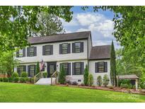 Charming two-story home with a lush green lawn and beautiful landscaping at 1119 Thornsby Ln, Matthews, NC 28105