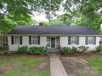 Charming one-story home featuring a symmetrical design, manicured landscaping, and inviting walkway at 121 Patrick St, Gastonia, NC 28054