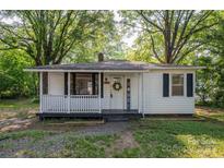 Charming one-story home with a welcoming front porch and well-maintained landscaping at 143 Hallman St, Cherryville, NC 28021