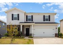 Charming two-story home featuring light siding, dark shutters, and a two-car garage at 164 Shepherds Landing Dr, Mooresville, NC 28115