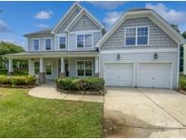 Charming two-story home featuring a manicured lawn and a two-car garage at 2479 N Legacy Park Blvd, Fort Mill, SC 29707