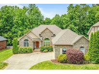 Charming brick home with manicured landscaping and a well-maintained front yard at 305 River Birch Cir, Mooresville, NC 28115
