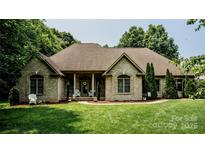Charming brick home with lush lawn and manicured landscaping creates inviting curb appeal at 3273 16Th Ne St, Hickory, NC 28601