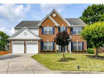 Charming two-story brick home with a well-manicured lawn and inviting curb appeal at 8608 Talbert Paige Ct, Charlotte, NC 28277