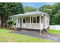 Charming single-story home featuring a cozy front porch and landscaped garden at 1036 20Th Ne St, Hickory, NC 28601