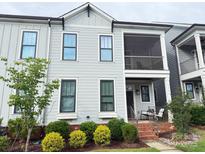 Charming two-story townhome with a screened porch and landscaped front yard at 114 Mint Ave # A, Mooresville, NC 28117