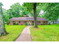 Charming single-story brick home with a well-manicured lawn and inviting walkway at 1304 5Th Street Nw Cir, Hickory, NC 28601