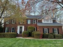 Traditional brick two-story home with manicured lawn and black shutters, offering classic curb appeal at 21621 Crown Lake Dr, Cornelius, NC 28031