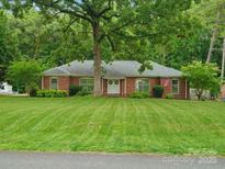 Charming brick home with a manicured lawn and mature trees, creating a serene and inviting curb appeal at 3367 Tanglewood Dr, Rock Hill, SC 29732