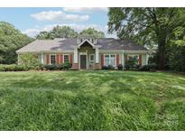 Charming single-story home featuring red shutters, a well-manicured lawn, and inviting curb appeal at 3916 Blowing Rock Way, Charlotte, NC 28210