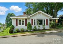 Charming single-story home with red shutters, lush landscaping, and a covered carport under a sunny sky at 435 Sixteenth St, Cramerton, NC 28032