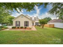 Charming one-story home with a manicured lawn and mature trees, creating a welcoming curb appeal at 5436 Scarlet Sage Dr, Charlotte, NC 28215